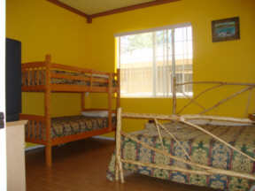 second bedroom with bunk beds and full size bed